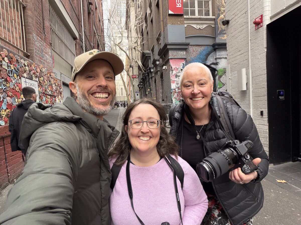Two students and Daniel Bilsborough in a Melbourne CBD laneway during a photography course